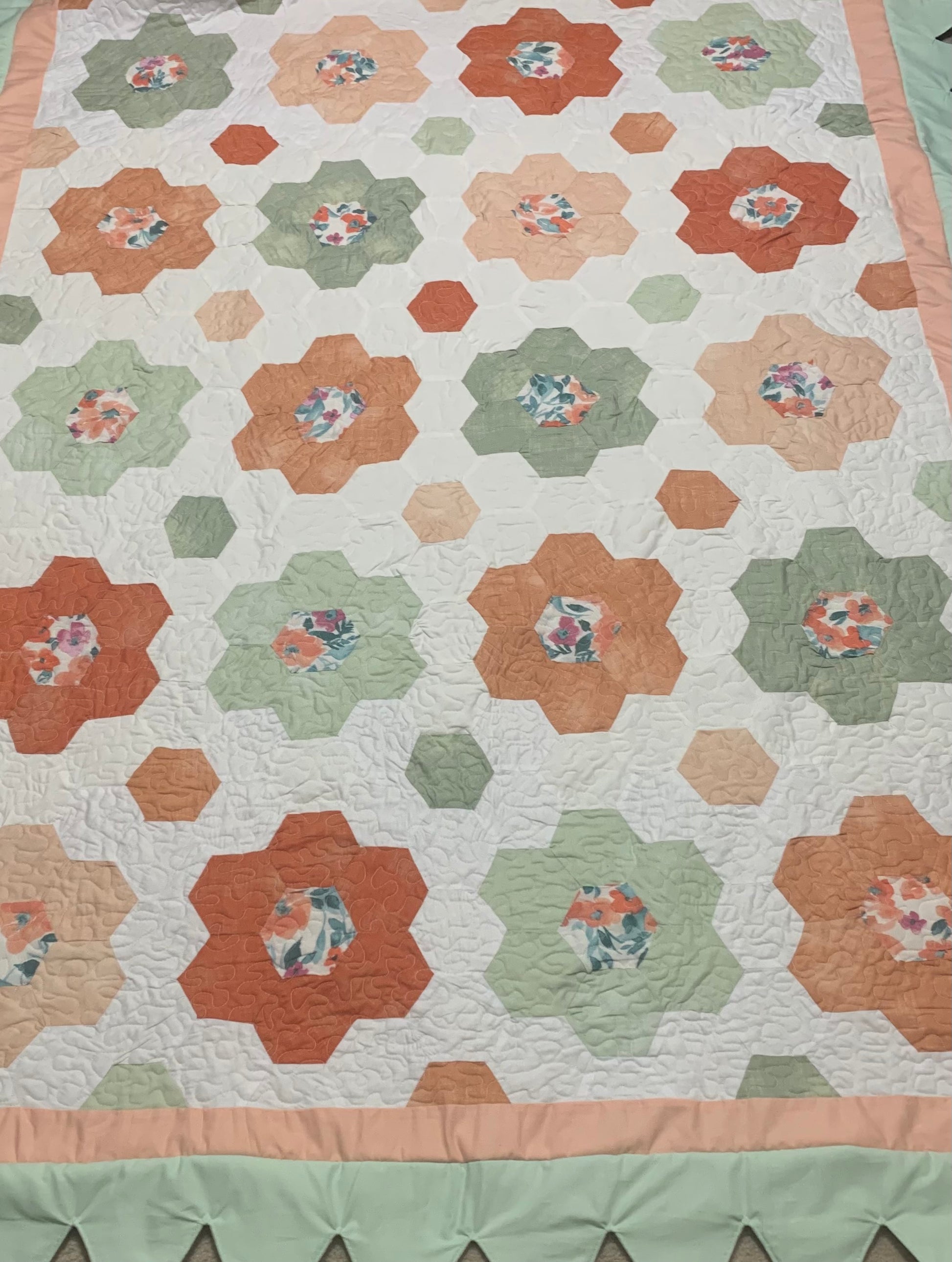 LW Designs throw size hexagon flower quilt with colorful hexagon patterns and floral embroidery on soft fabric.