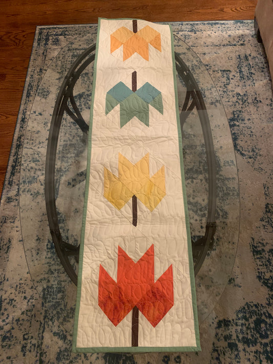 Quilted LW Designs table runner with a textured, stitched pattern, perfect for enhancing dining table decor.