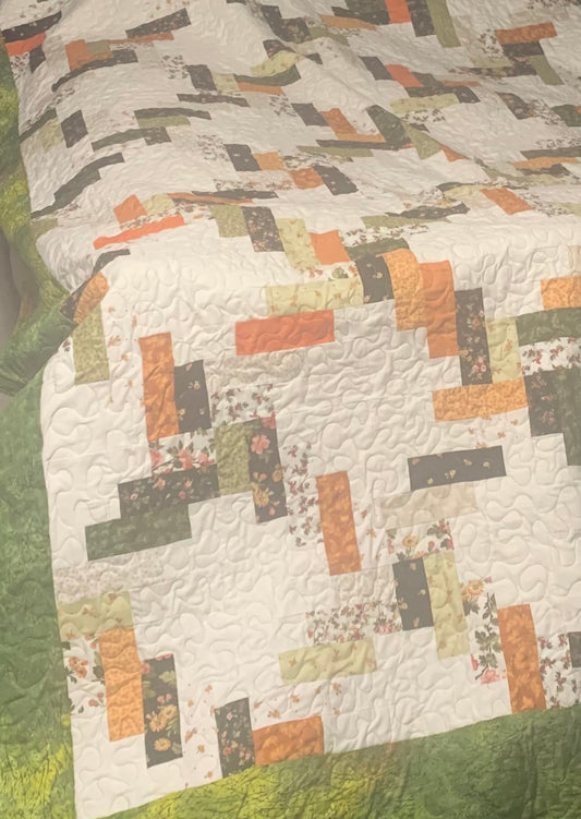 Custom fall quilt by LW Designs featuring warm autumn colors and intricate patchwork, perfect for cozying up in autumn.