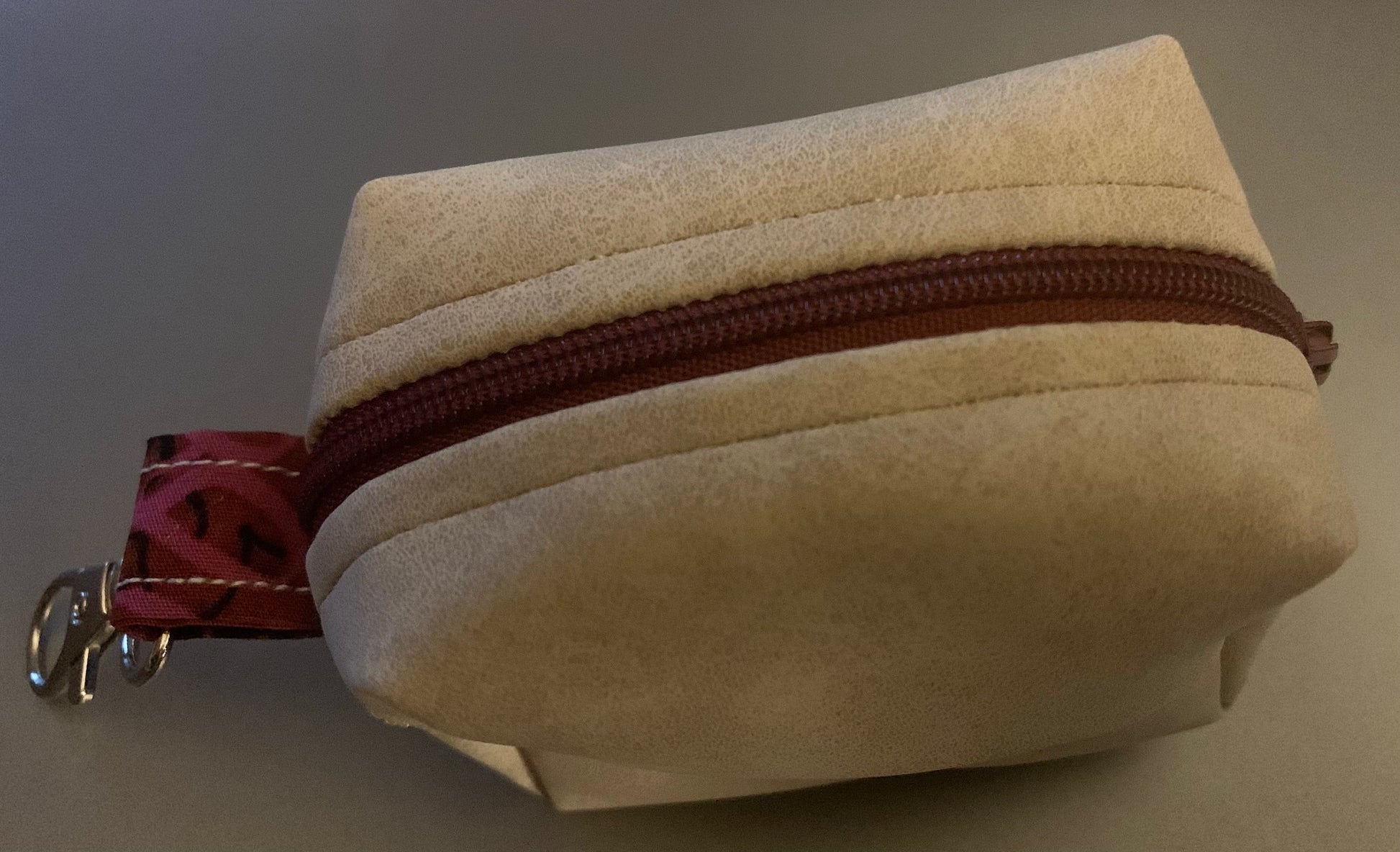 LW Designs poop bag holder featuring a compact, stylish design with a metal clip and colorful fabric for dog walks.