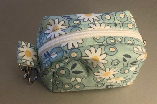 LW Designs poop bag holder with clip and loop, compact and stylish for carrying pet waste bags during walks.