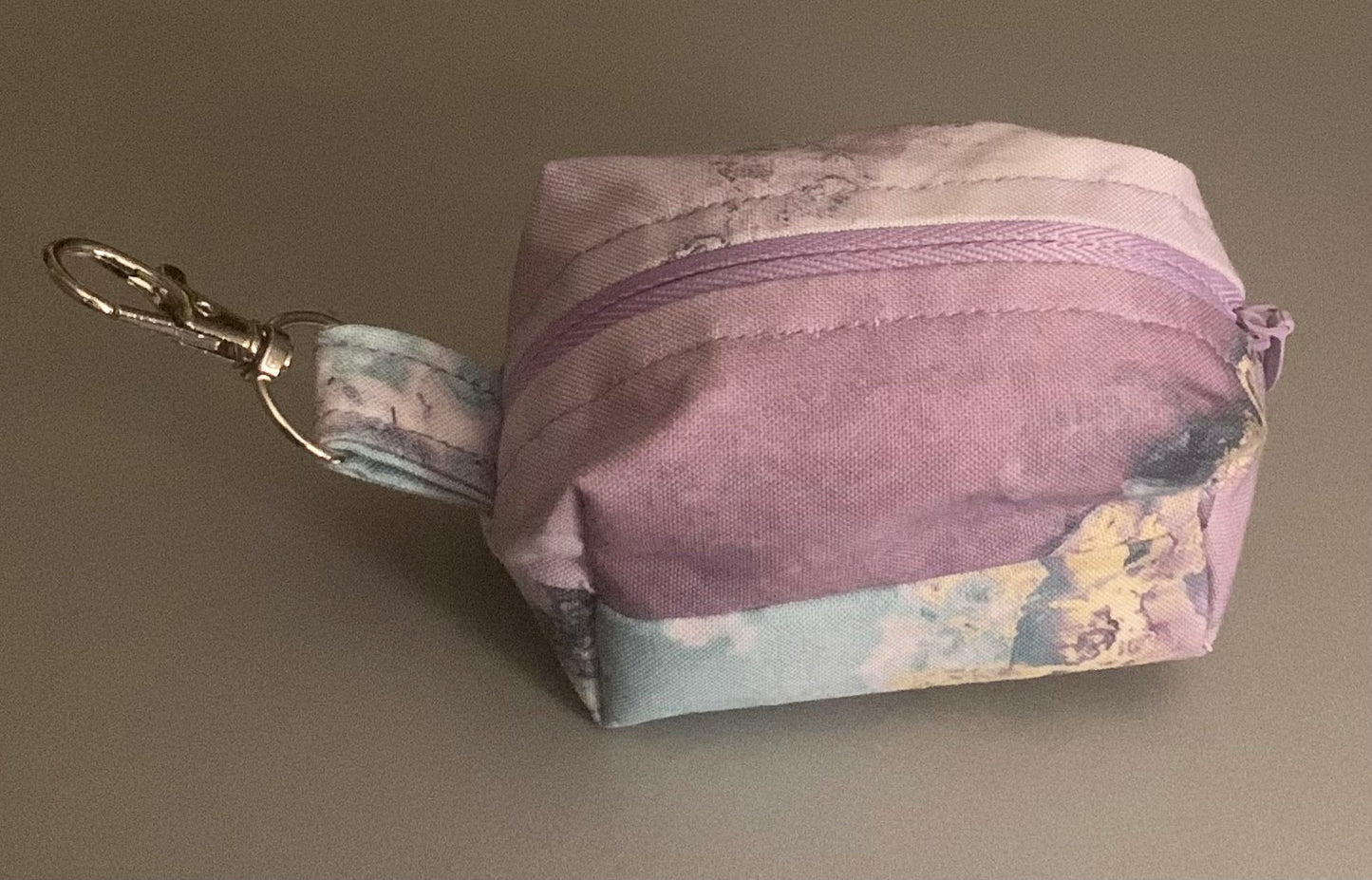 LW Designs poop bag holder attached to a leash, featuring a compact, stylish design for outdoor dog walks.
