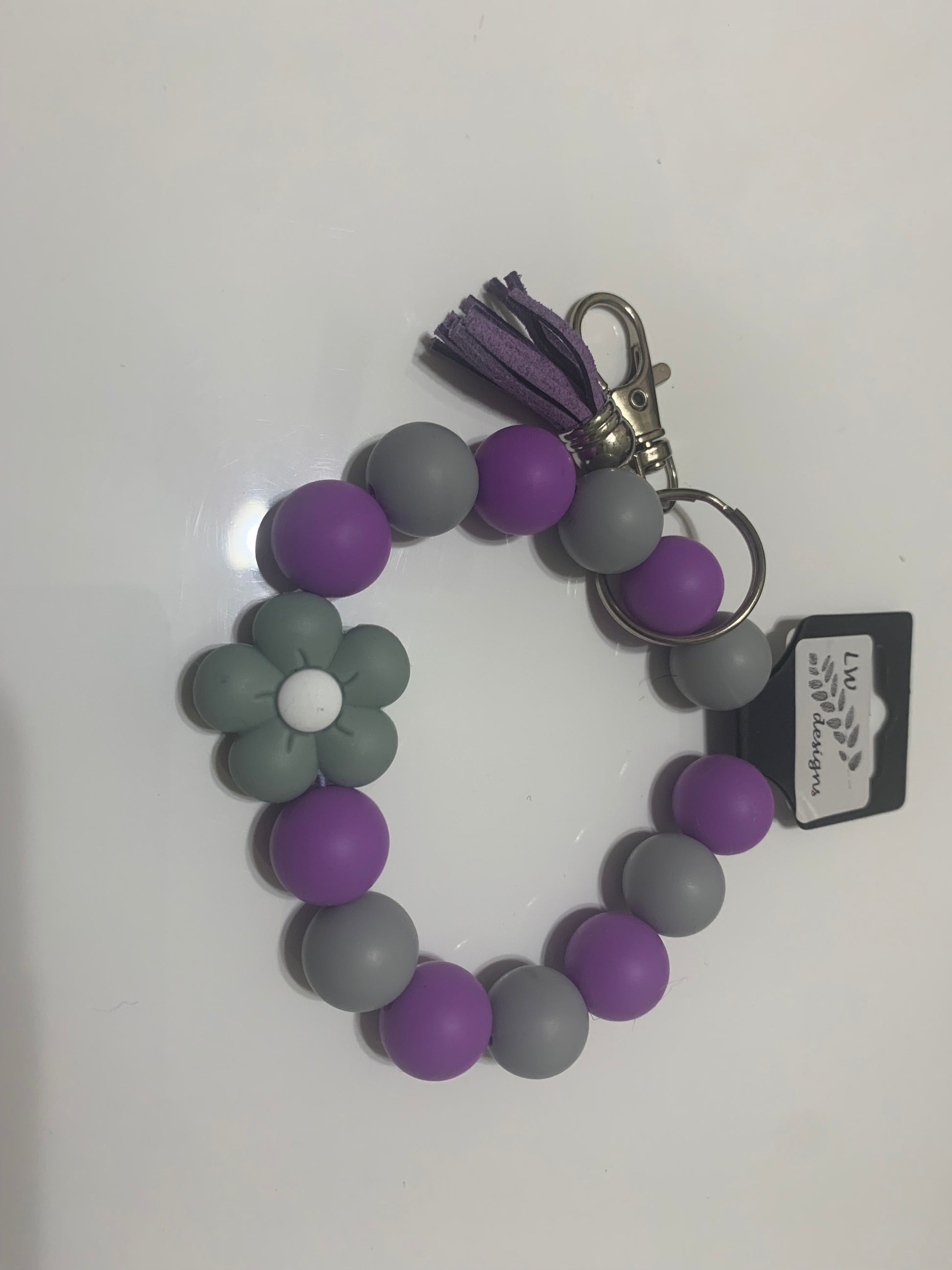 Beaded wristlet or keychain with colorful beads and LW Designs branding, featuring a decorative and functional accessory.
