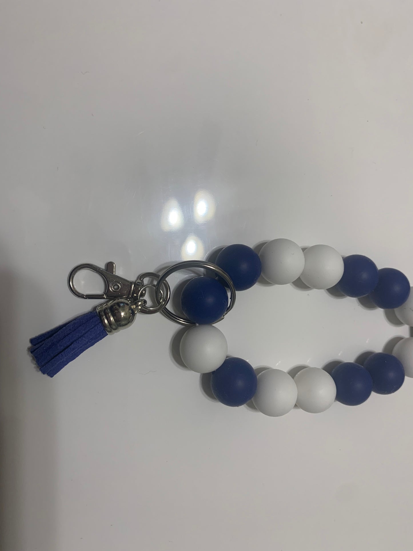 Beaded wristlet keychain by LW Designs featuring colorful beads and a decorative charm on a neutral background.