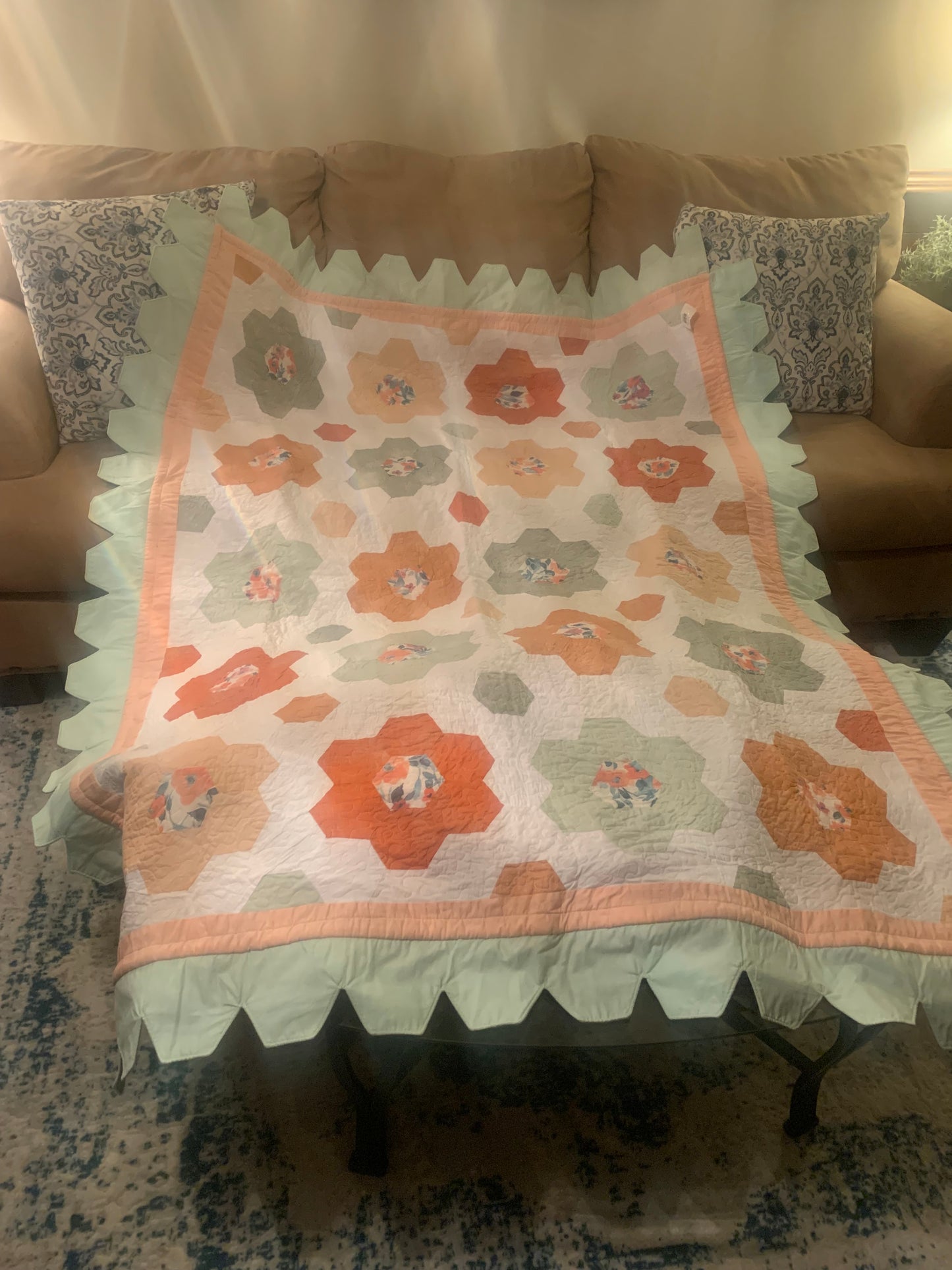 Throw size hexagon flower quilt by LW Designs featuring colorful hexagon floral patchwork on soft fabric.
