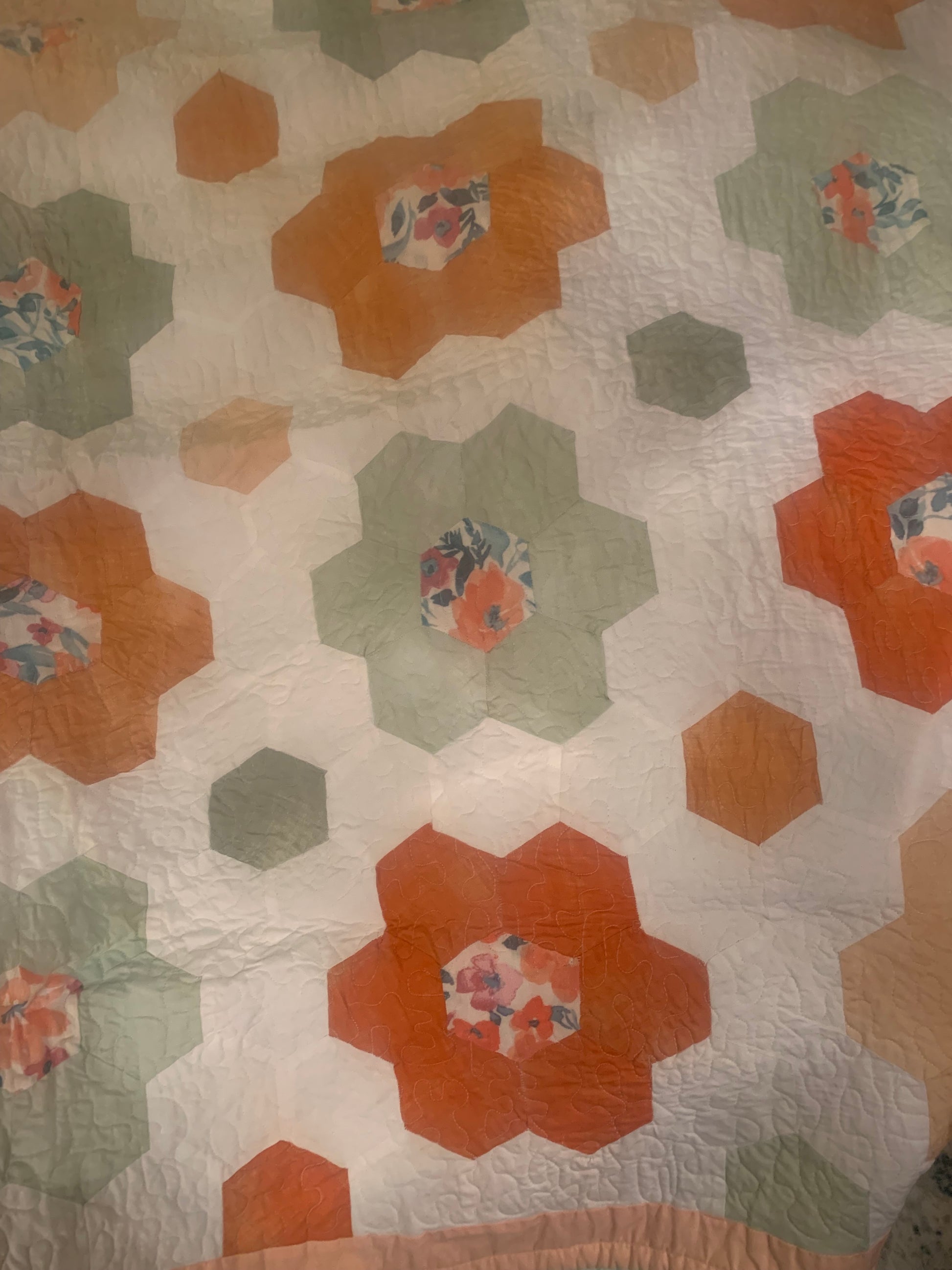 LW Designs throw size hexagon flower quilt showcasing a colorful hexagon pattern and floral design on soft fabric.