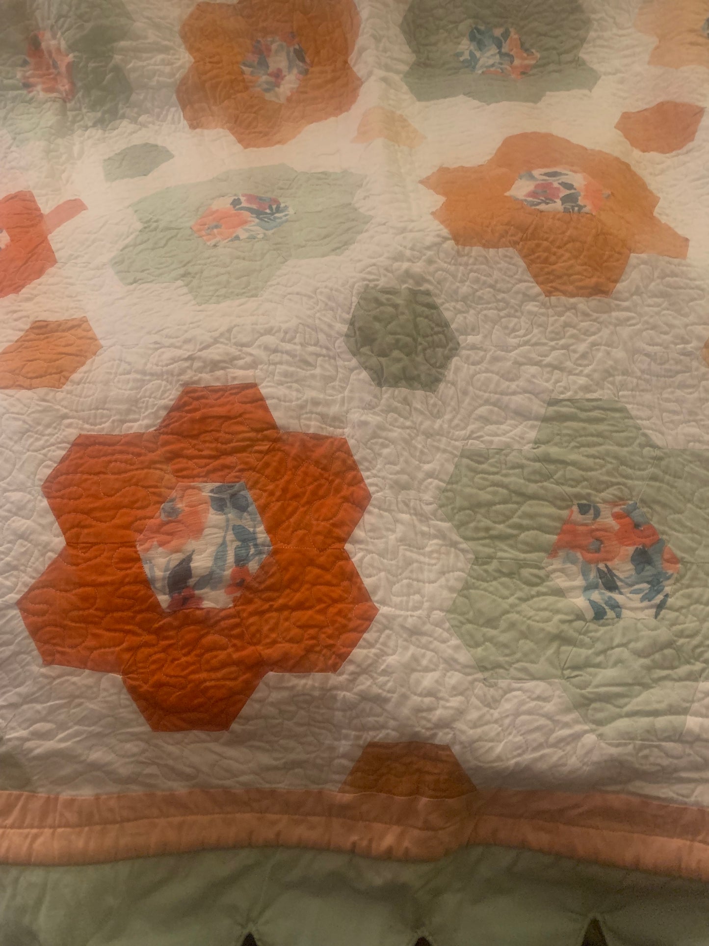 LW Designs throw size hexagon flower quilt with colorful hexagon patterns and floral designs on soft fabric.